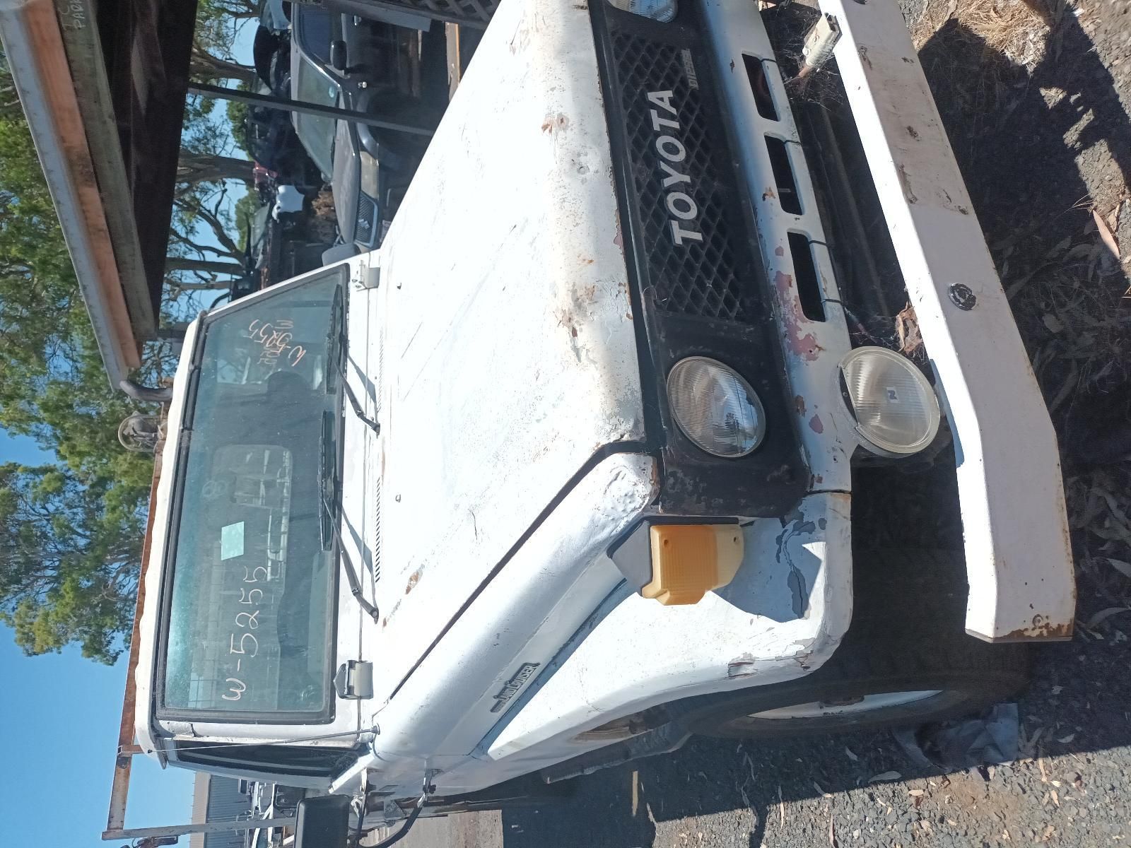 A White Toyota Truck is Parked on the Side of the Road — South West 4WD Wreckers in Harristown, QLD
