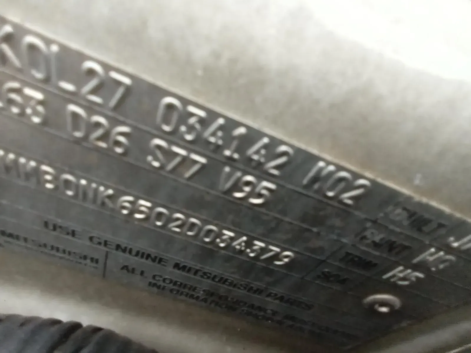 Close-up of a Metal Plate With Stamped Text Including Numbers — South West 4WD Wreckers In Brisbane, QLD