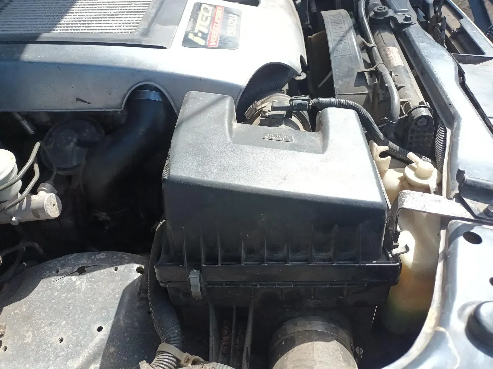 Engine Compartment of a Vehicle With a Black Air Filter Box and Various Components — South West 4WD Wreckers In Brisbane, QLD