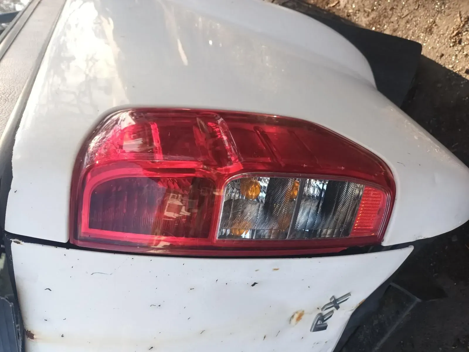 White Car Rear With Red Taillight, Showing Brake Lights and Turn Signal — South West 4WD Wreckers In Brisbane, QLD