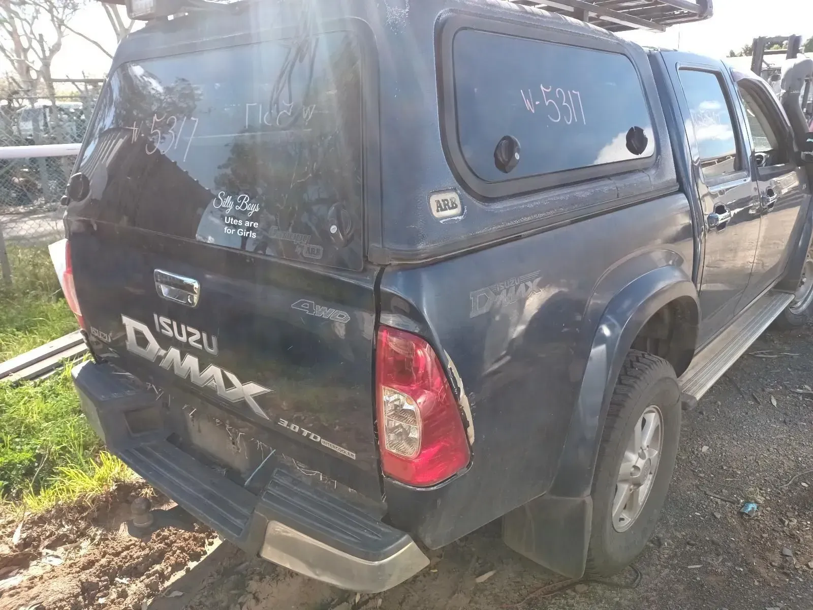 Dark Blue Isuzu D-max Pickup Truck With a Camper Shell, Parked Outside — South West 4WD Wreckers In Brisbane, QLD