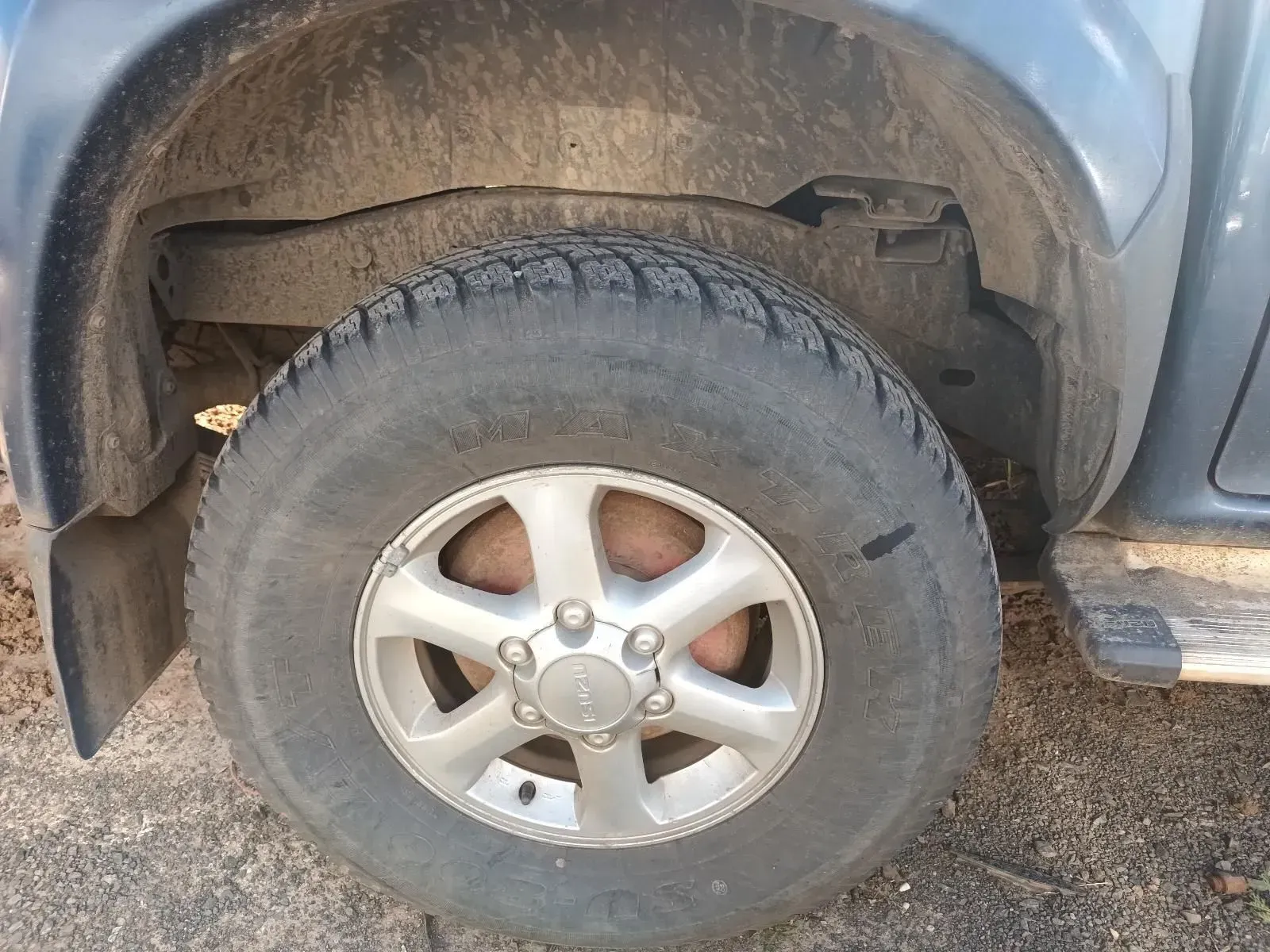 Blue Truck's Front Tyre, Silver Rim, Dark Tyre Tread, Dirty Wheel Well — South West 4WD Wreckers In Brisbane, QLD
