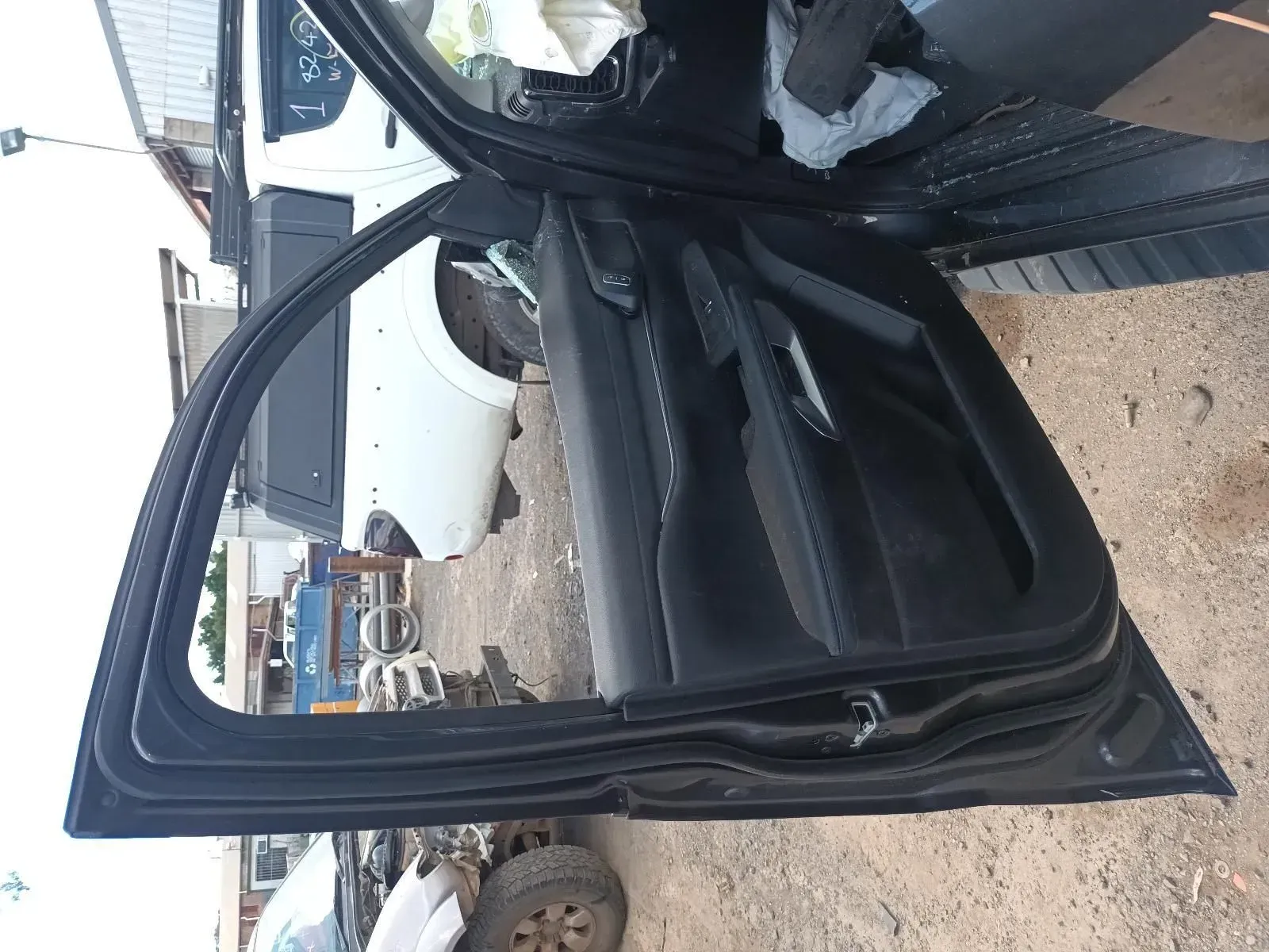 Black Car Door Open at a Junkyard, Revealing the Interior — South West 4WD Wreckers In Brisbane, QLD