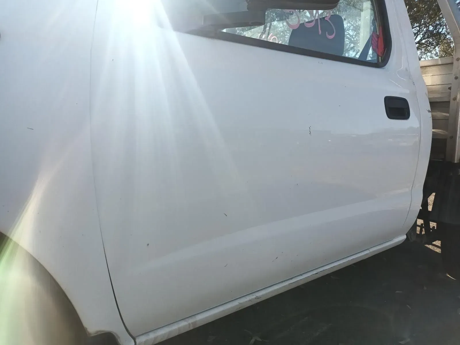 White Vehicle Door, Side View, Black Handle, Slight Sun Glare — South West 4WD Wreckers In Brisbane, QLD