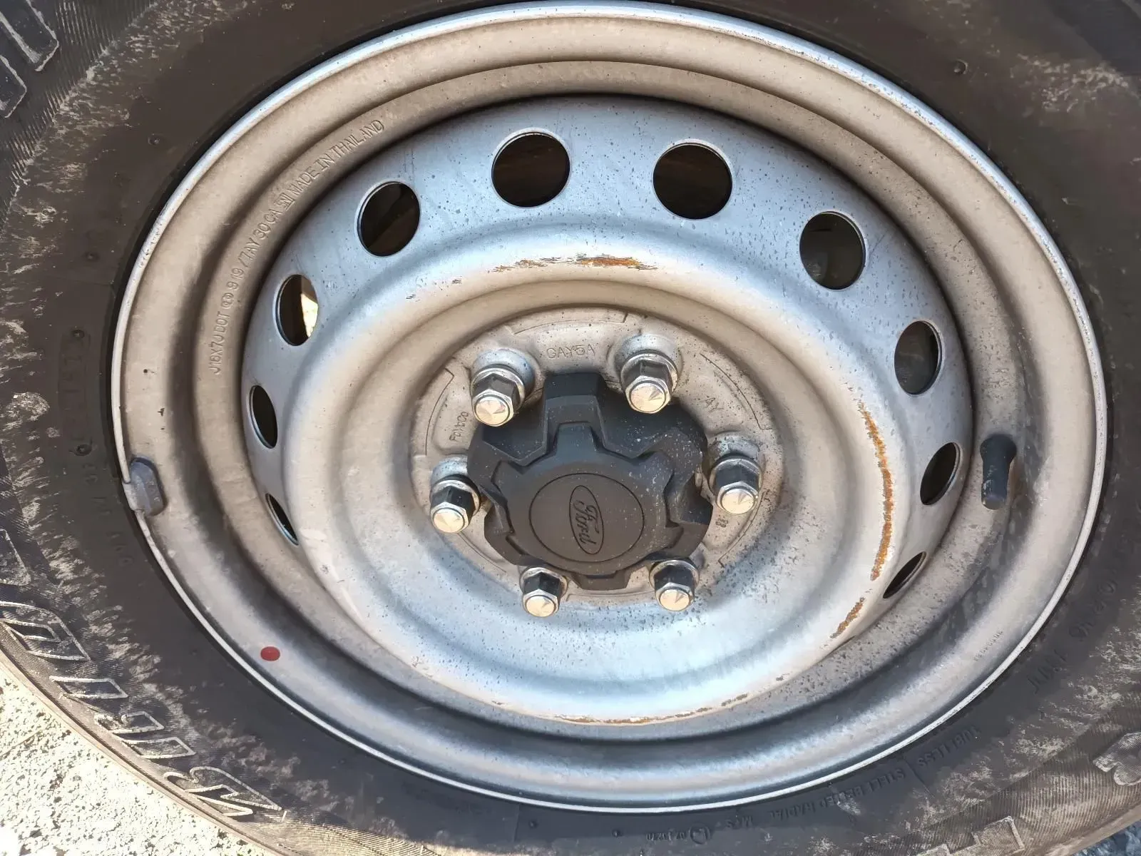 Close-up of a Vehicle Wheel, Steel Rim, and Black Tyre; Ford Hubcap With Lug Nuts — South West 4WD Wreckers In Brisbane, QLD