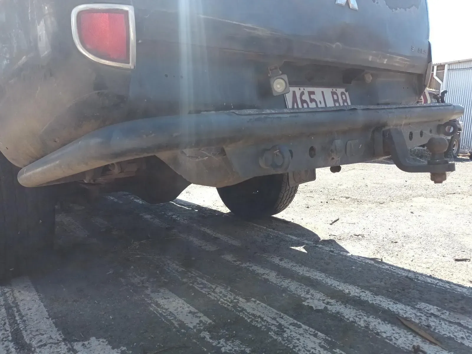 Back of a Dark Truck on a Ramp, Showing Bumper, License Plate, and Hitch — South West 4WD Wreckers In Brisbane, QLD