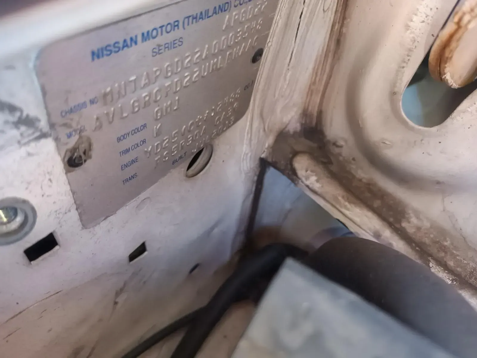 Silver Nissan Data Plate in White Engine Compartment — South West 4WD Wreckers In Brisbane, QLD