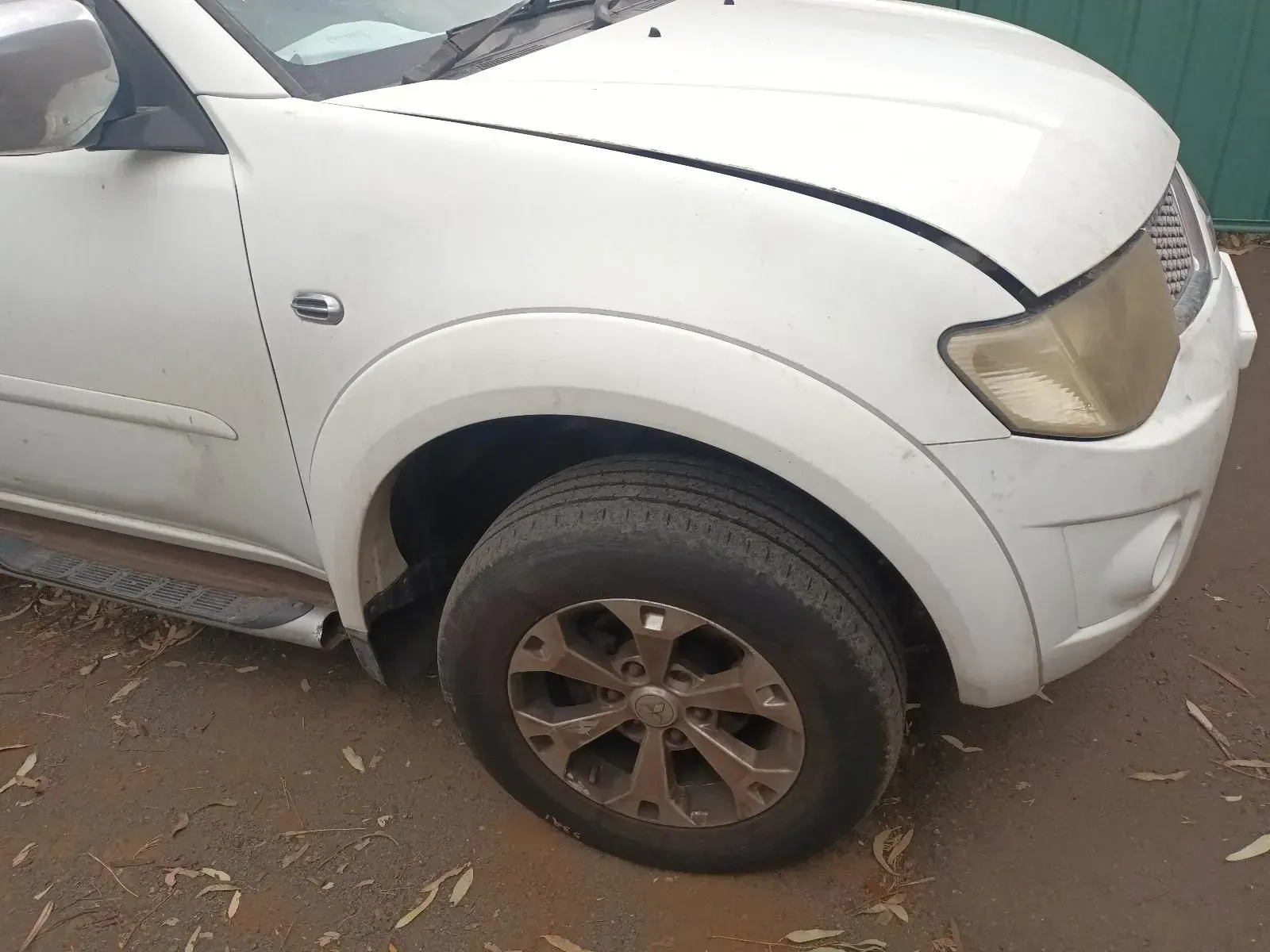 White Mitsubishi Triton Truck, Front-side View, With a Dirty Tyre — South West 4WD Wreckers In Brisbane, QLD