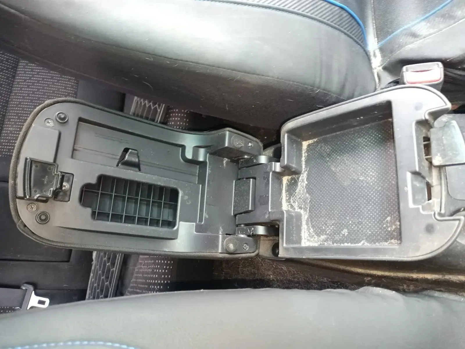 Open Car Center Console, Black Plastic, With Dust and Debris Inside — South West 4WD Wreckers In Brisbane, QLD