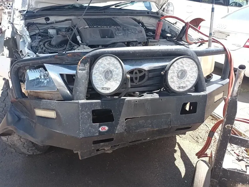 A Toyota Truck With the Hood Up is Parked on the Side of the Road — South West 4WD Wreckers In Brisbane, QLD