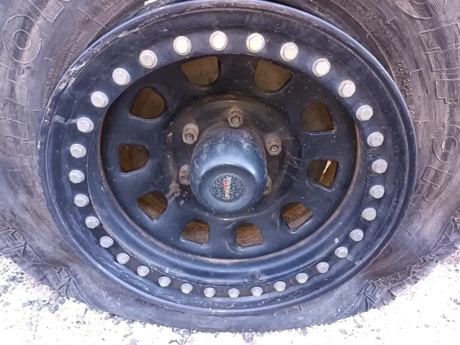 Black Off-road Wheel With Numerous Bolts Around the Rim — South West 4WD Wreckers In Brisbane, QLD