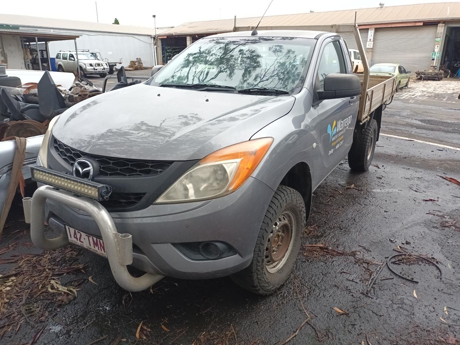 A Gray Truck with a Tray on the Back is Parked in a Parking Lot — South West 4WD Wreckers in Harristown, QLD