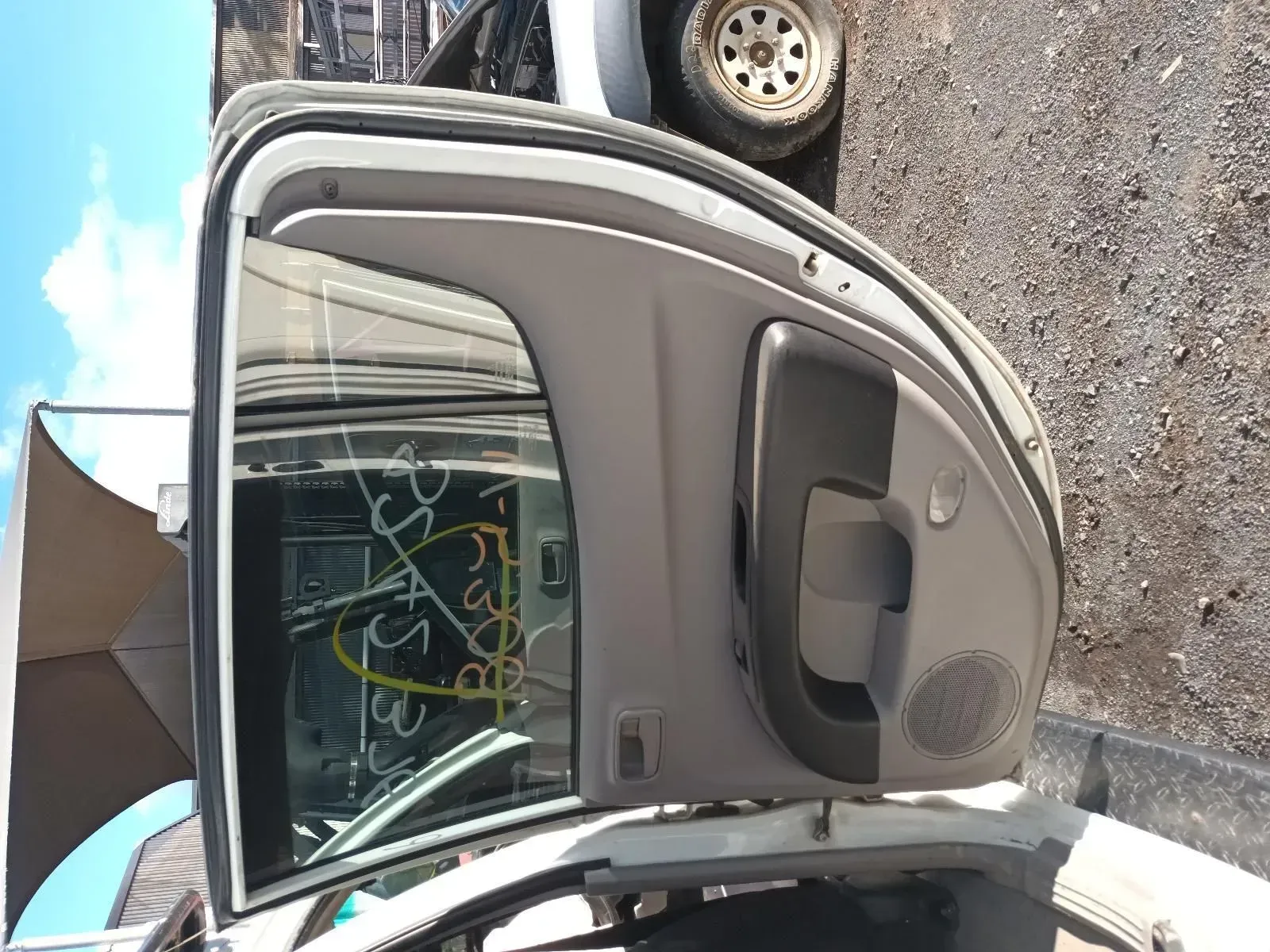 Tan Car Door in a Salvage Yard, With Glass and Interior Panel Visible — South West 4WD Wreckers In Brisbane, QLD