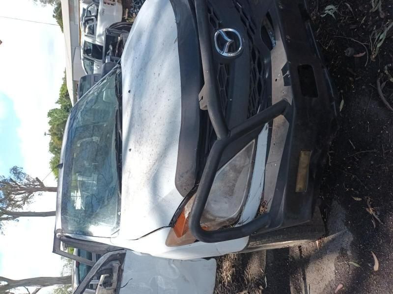 A White Mercedes Van is Sitting in the Dirt — South West 4WD Wreckers In Harristown, QLD