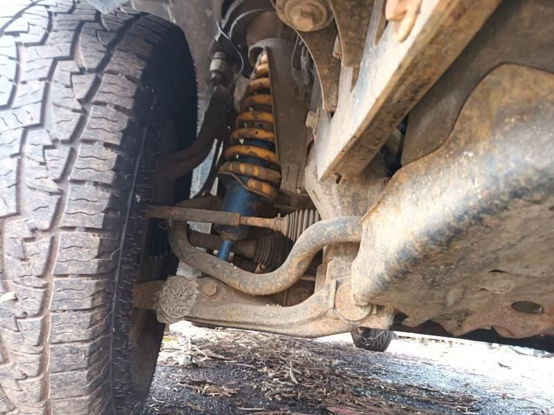 A Close Up of the Underside of a Car With a Shock Absorber and a Tire — South West 4WD Wreckers In Harristown, QLD