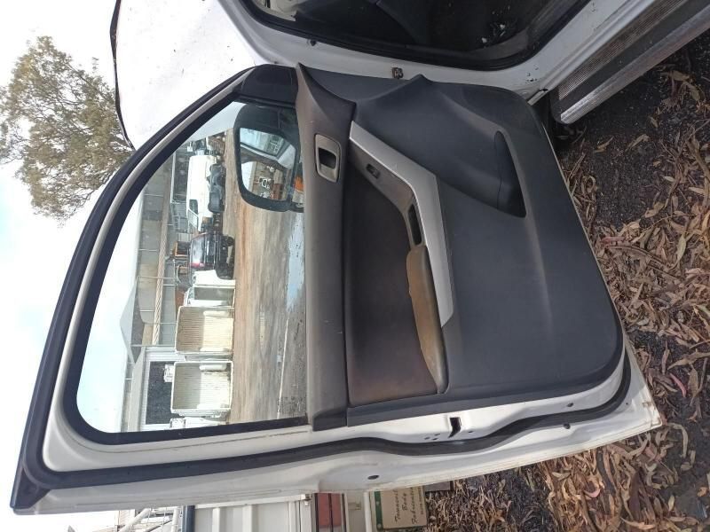 The Door of a White Car is Open and Sitting on the Ground — South West 4WD Wreckers In Harristown, QLD