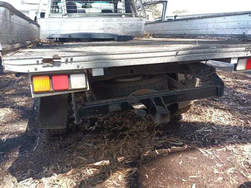 The Back of a Truck is Sitting in the Dirt — South West 4WD Wreckers In Harristown, QLD