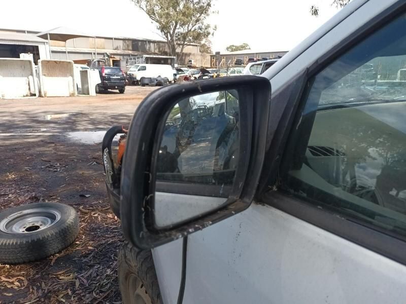 A Dirty Side View Mirror on a White Car — South West 4WD Wreckers In Harristown, QLD