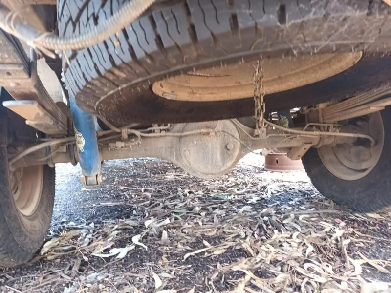 A Close Up of the Underside of a Truck With a Tire on the Ground