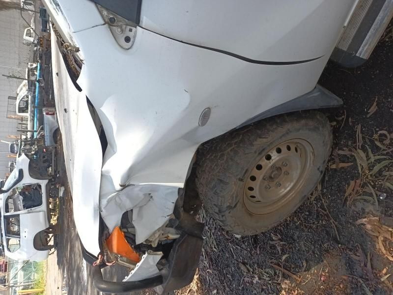 A White Car With a Damaged Front End is Parked on the Side of the Road — South West 4WD Wreckers In Harristown, QLD
