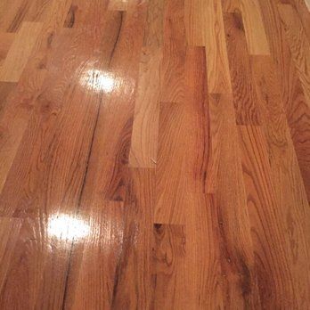Polished wooden hardwood floor with varying wood grain patterns.