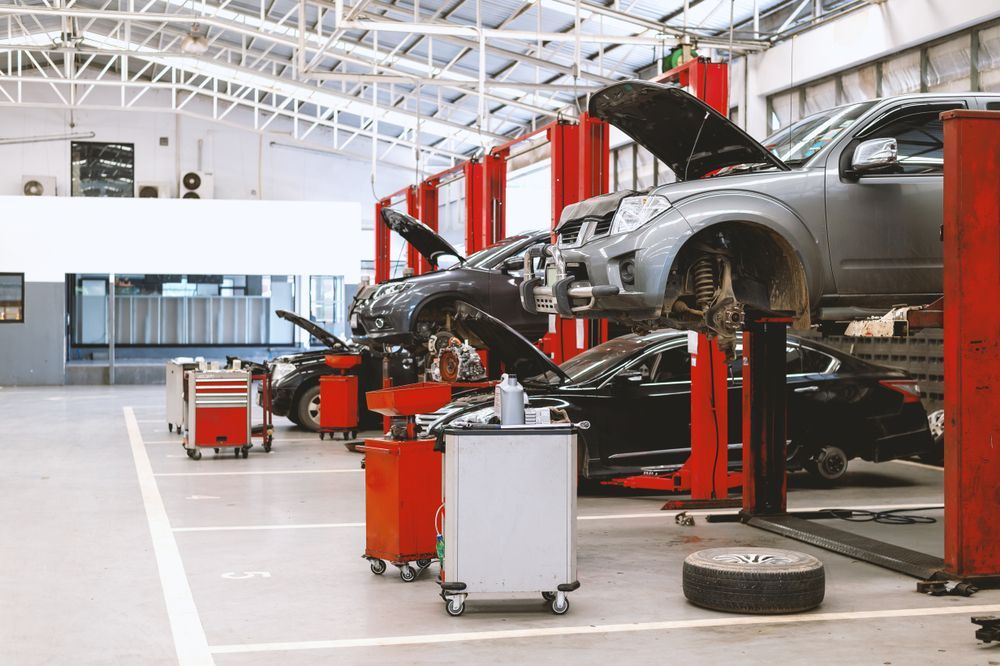 A Wide, Bright Auto Repair Shop With Multiple Cars — O'Toole Automotive In Tuggerah, NSW