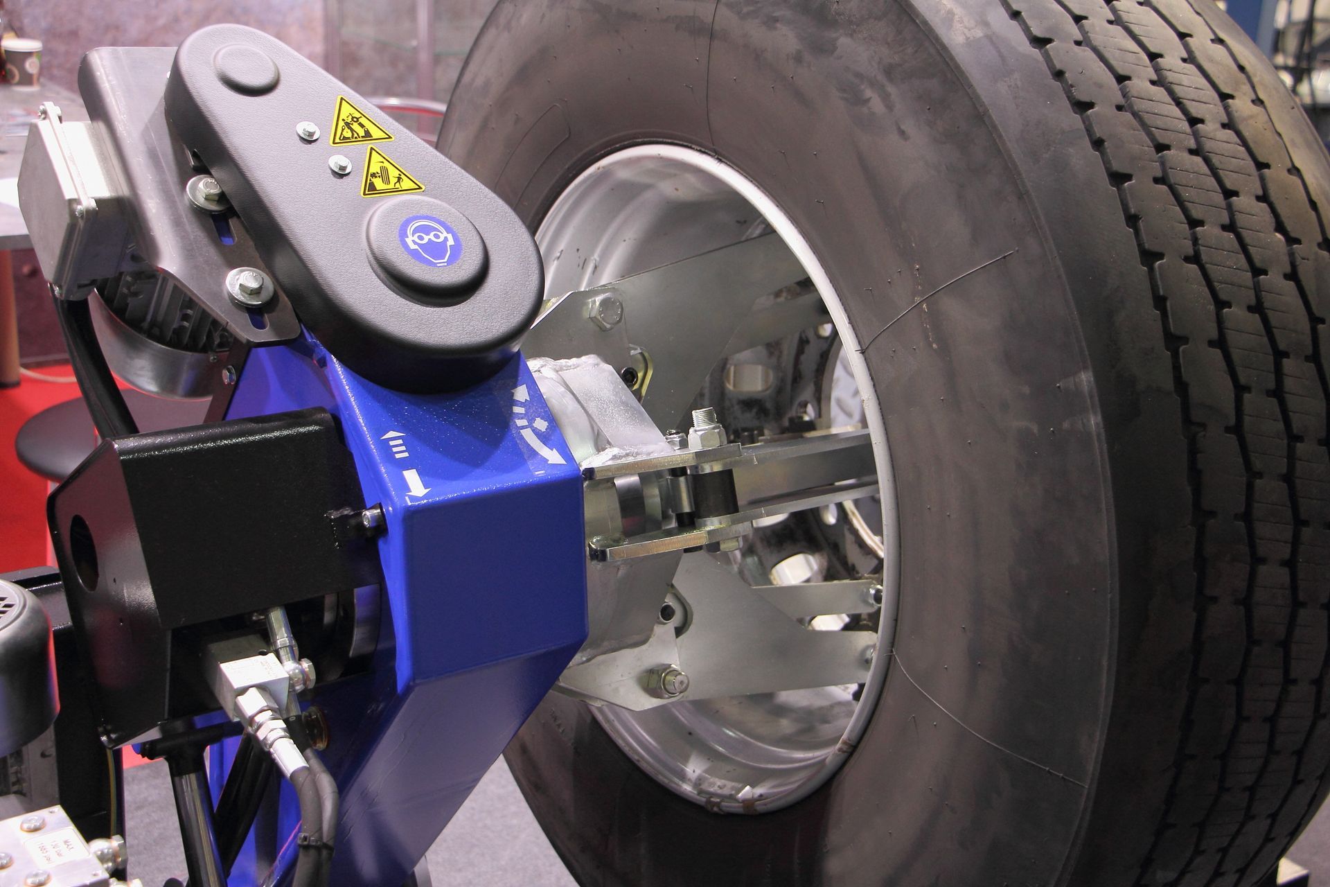 A Blue Tire Changer Machine Mounted on a Truck Wheel and Tire Assembly — O'Toole Automotive In Tuggerah, NSW