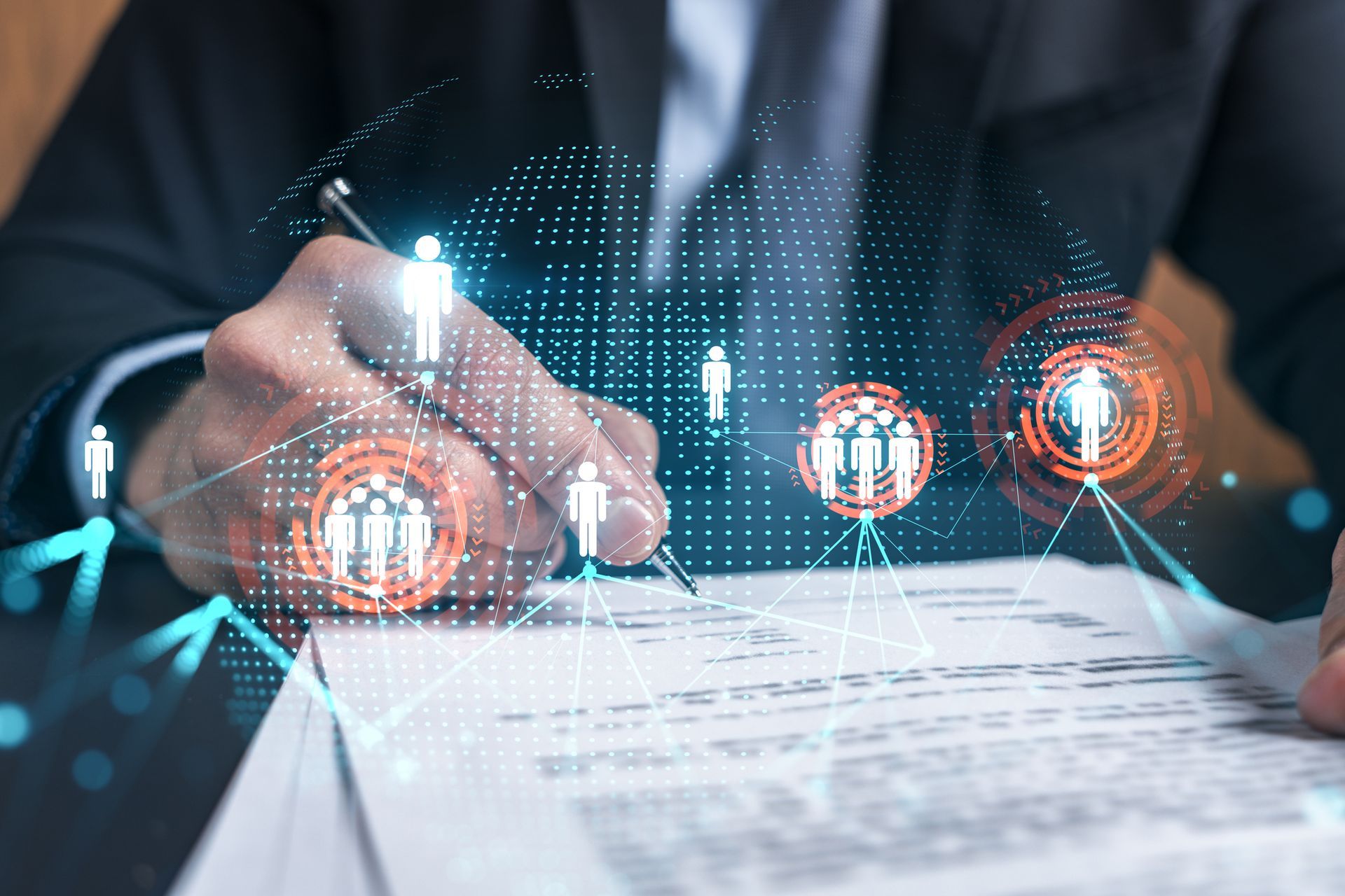 A man in a suit is signing a document with a pen.