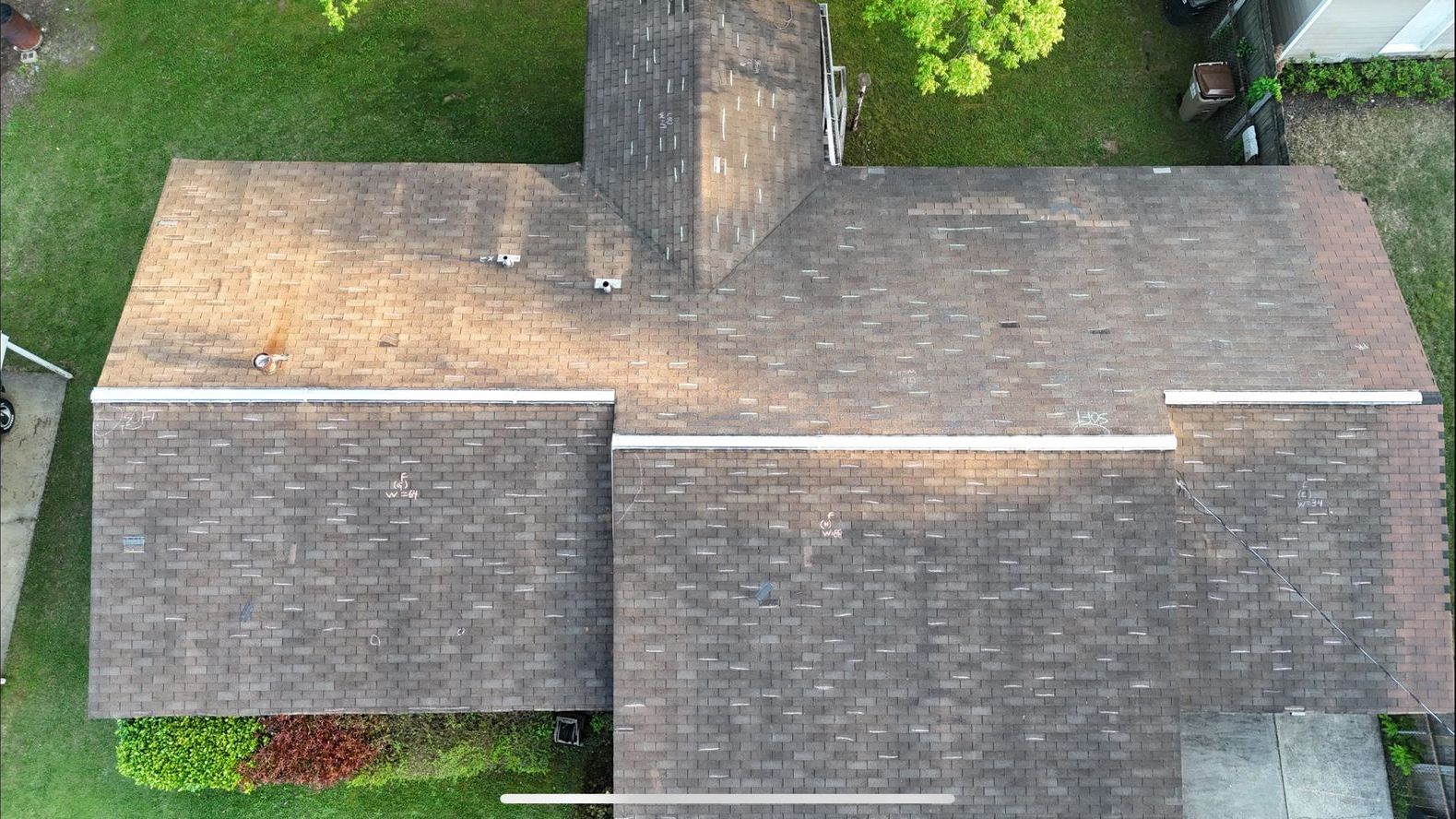 An aerial view of a roof of a house with a chimney