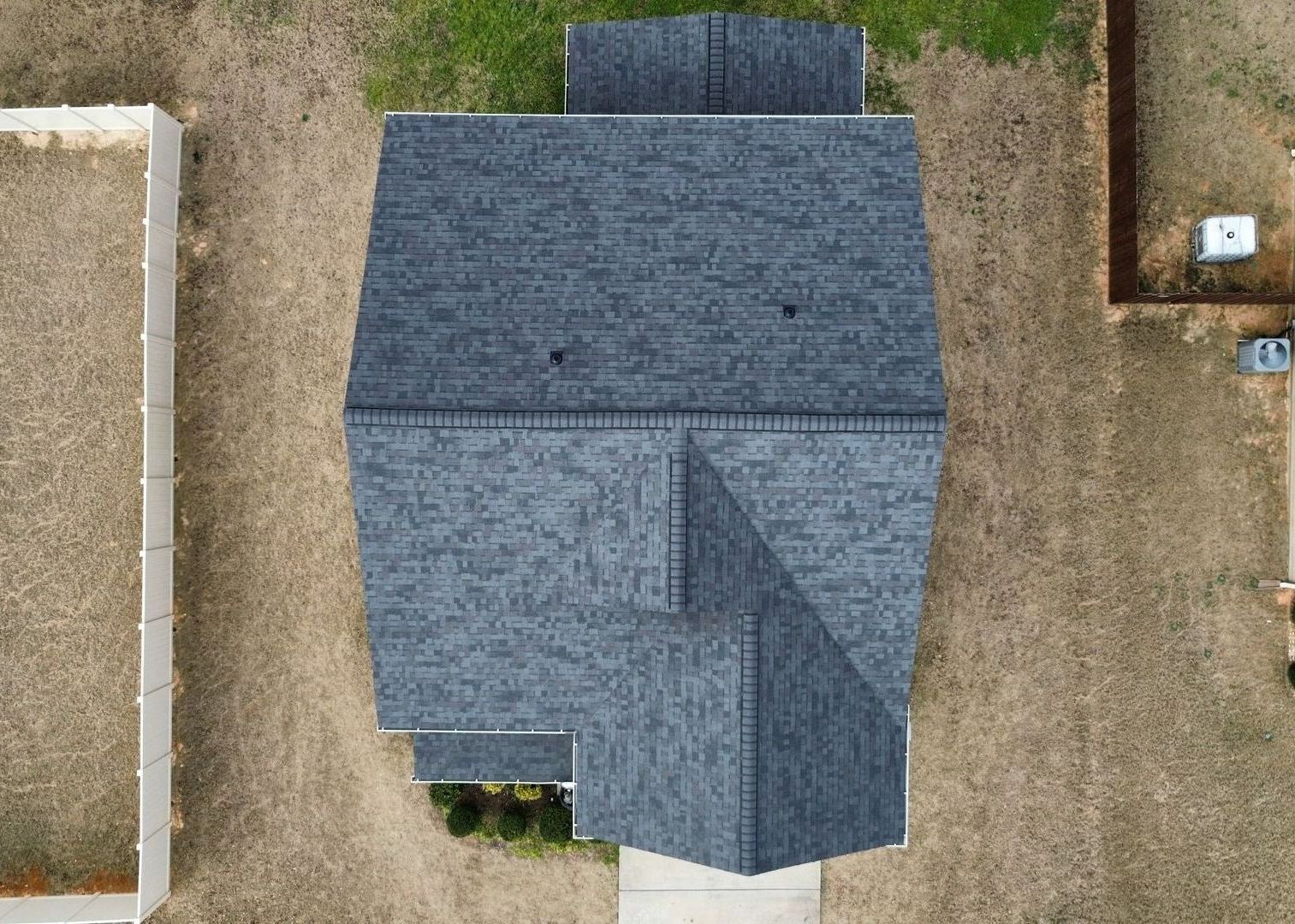 An aerial view of a house with a blue roof