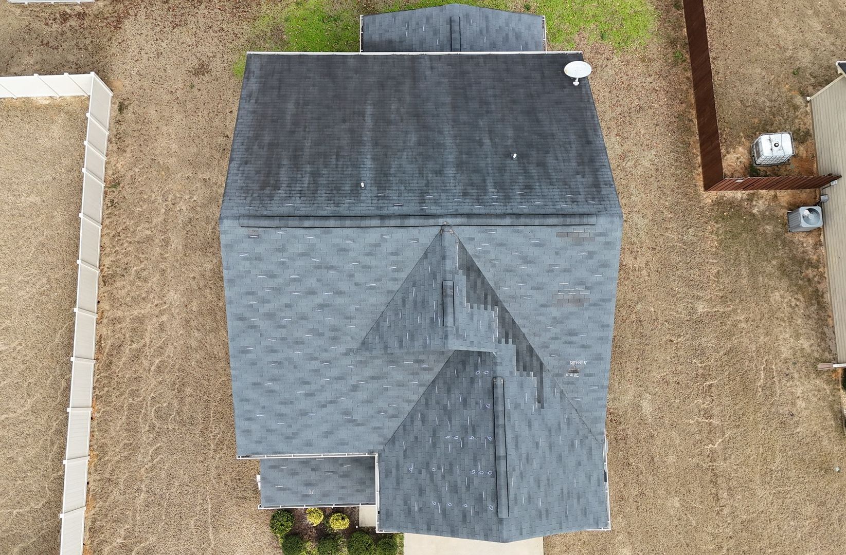 An aerial view of a house with a black roof