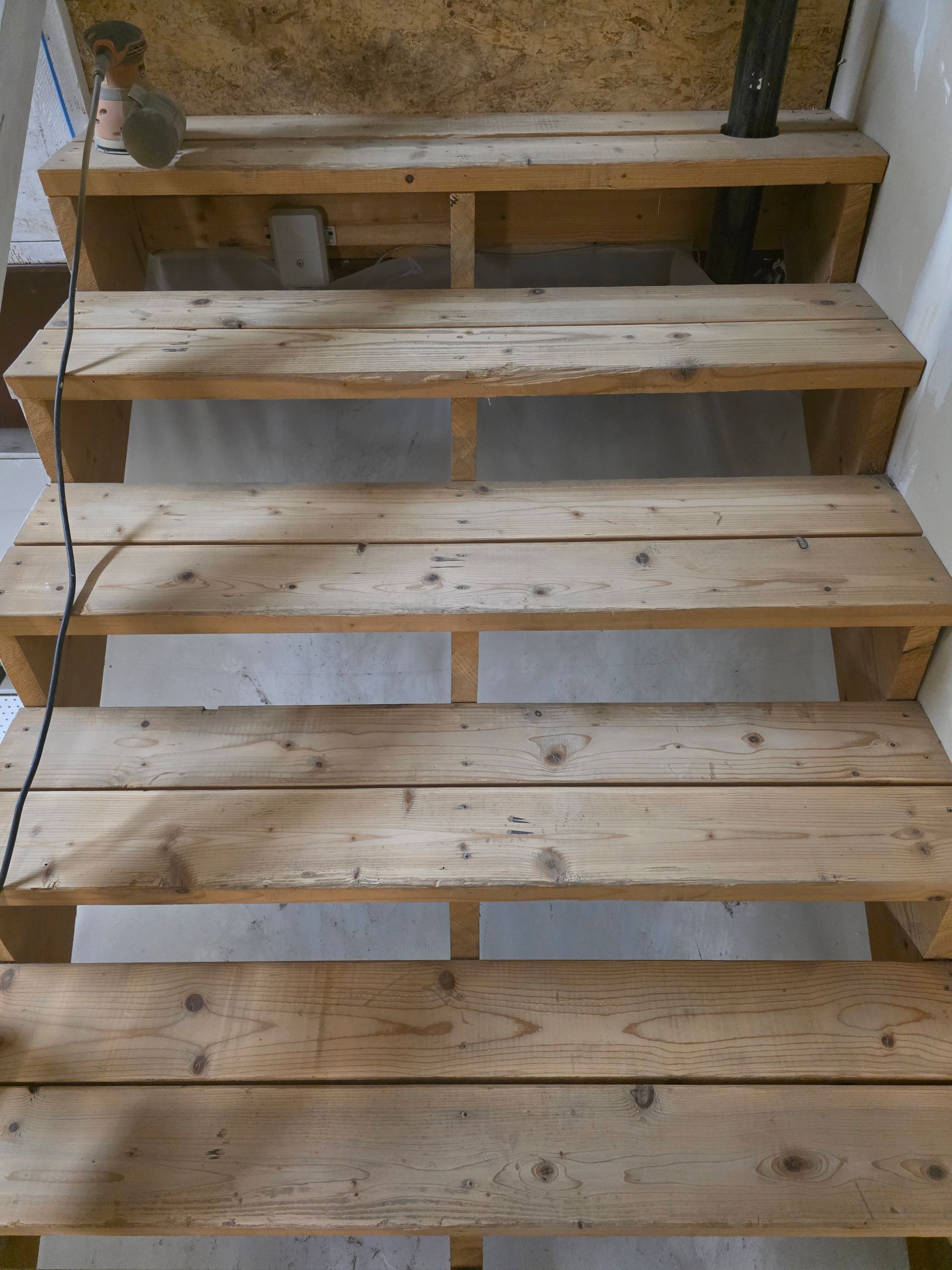 Wooden staircase made from planks; interior setting.