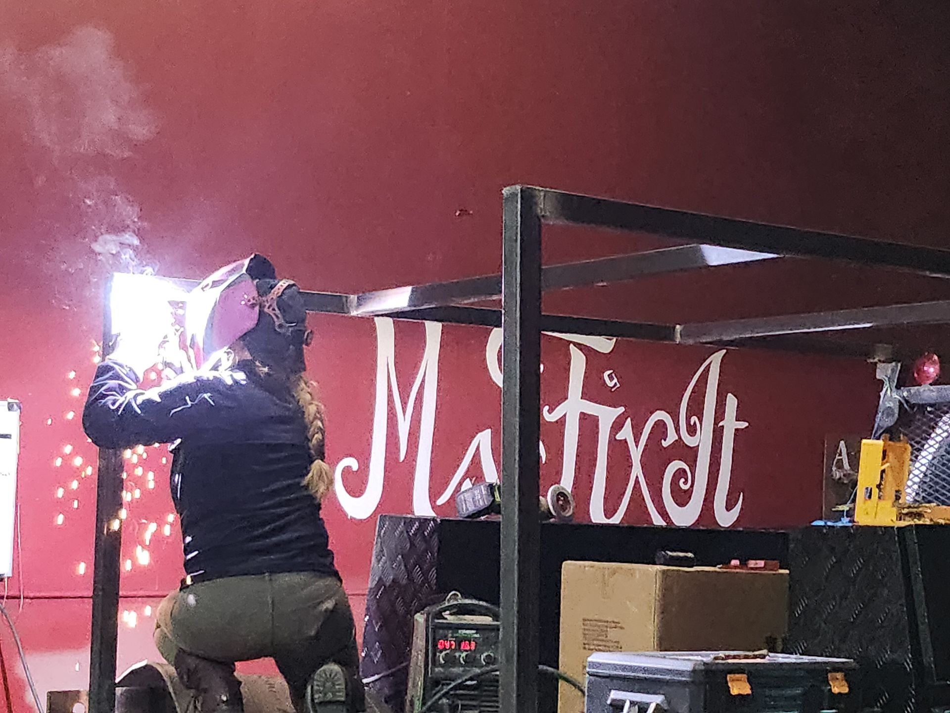Teresa Ley, Ms Fix It, welding metal, sparks flying.