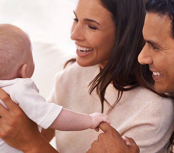 Happy Couple with a Baby — Hanover, PA — Strausbaugh Law PLLC