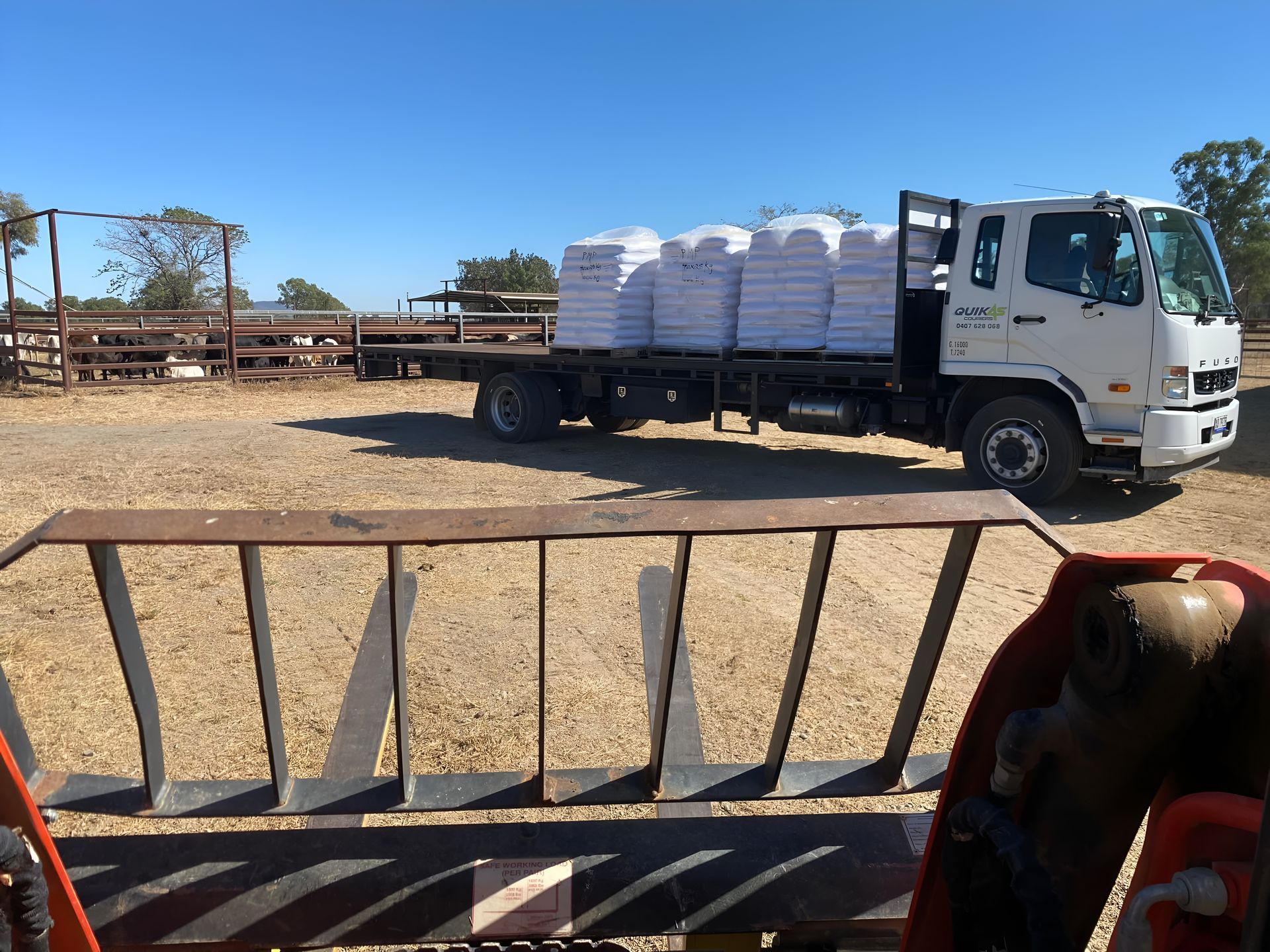 Red Pallet Jack Next to a Stack of Cardboard Boxes on a Tiled Floor — Quik As Couriers in Northern Beaches, NSW