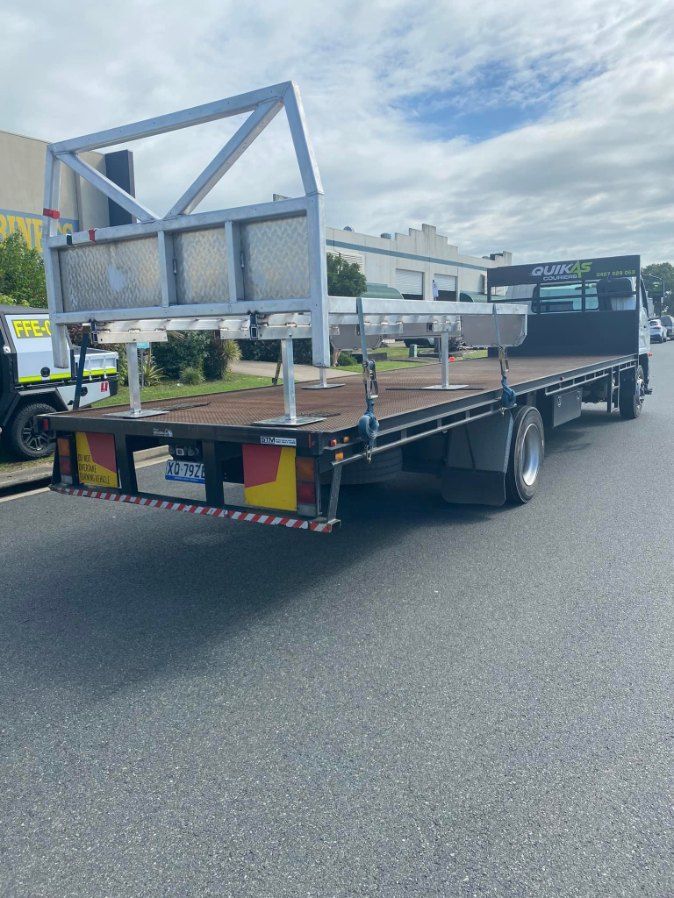 Flatbed Truck Parked on Asphalt Road, With a Metal Framework — Quik As Couriers in Rosella, QLD