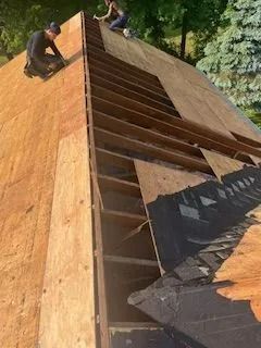 A group of people are working on a roof.