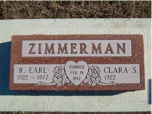 A gravestone for zimmerman with a heart and roses on it