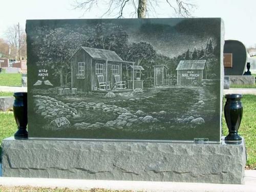 A gravestone with a picture of a house on it