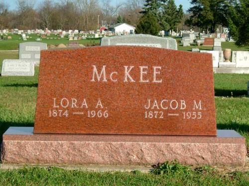 A red gravestone with the name mckee on it