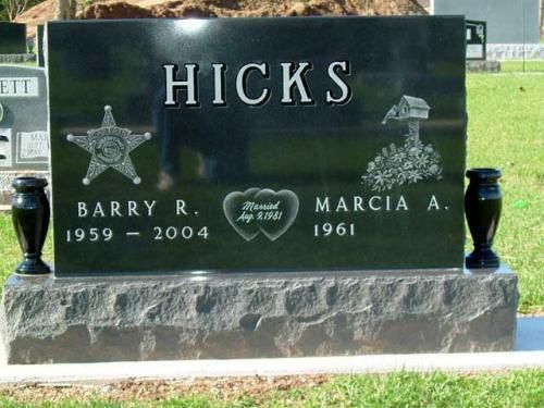 A black gravestone with the name hicks on it
