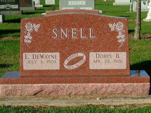 A red gravestone with the name snell on it