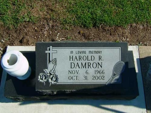 A gravestone for harold r. damron is in a cemetery