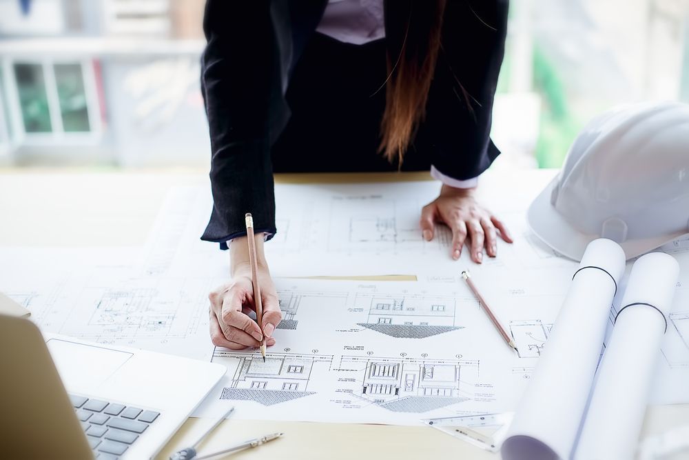 Architect Working On Blueprints, Pencil In Hand — GS Design & Drafting In Ballina, NSW