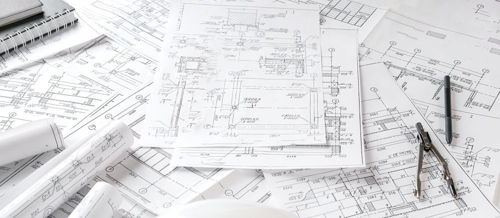 Architectural Blueprints On A Table With A Compass And Pen — GS Design & Drafting In Ballina, NSW