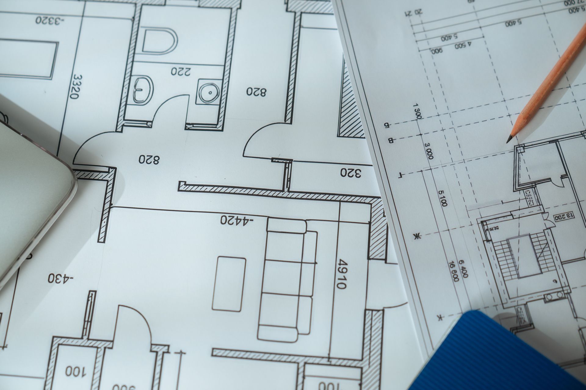Architectural Blueprints With A Pencil And A Partially Visible Laptop And Blue Pad — GS Design & Drafting In Lismore, NSW