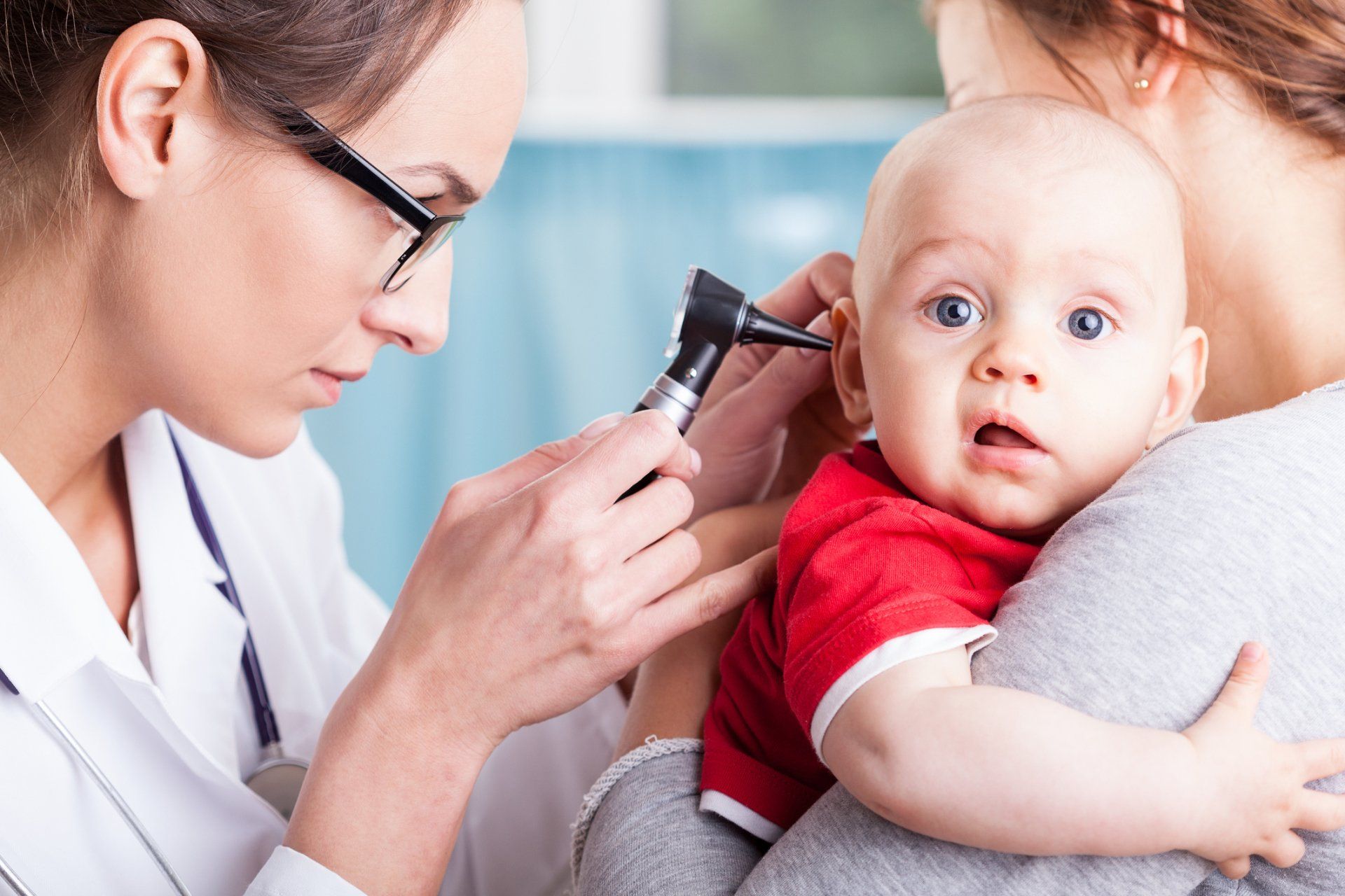 doctor checking baby's ears