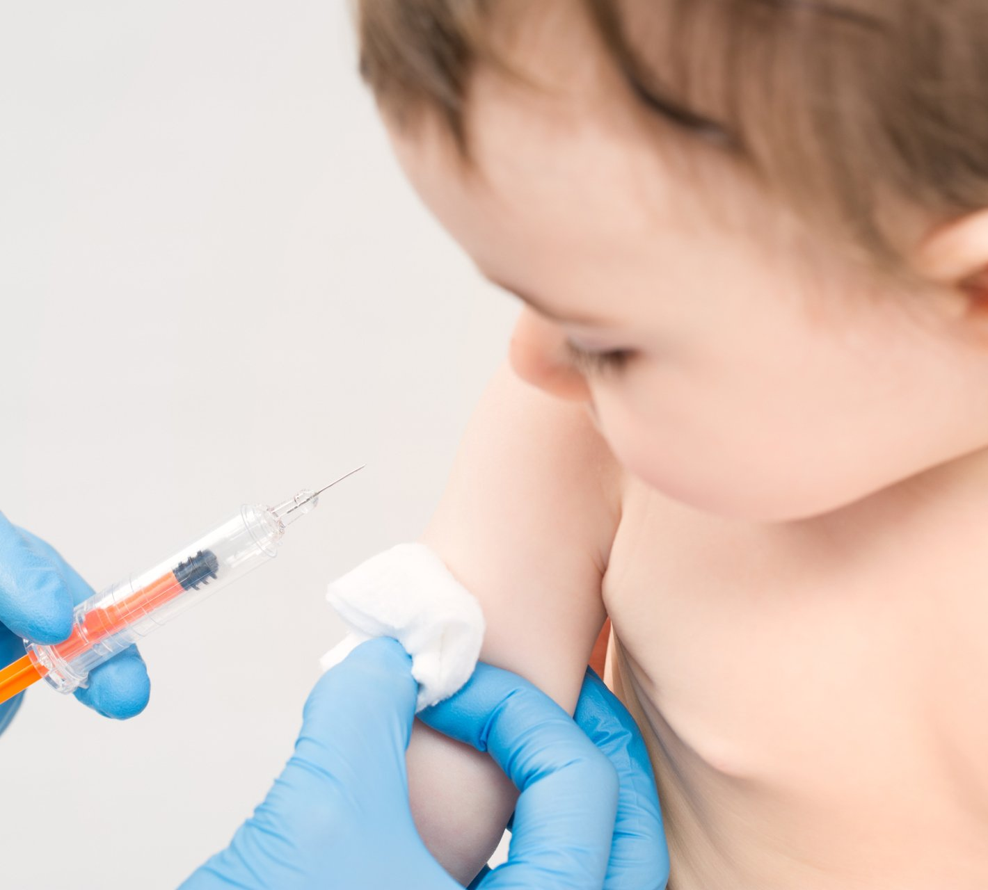Child receiving shot from doctor