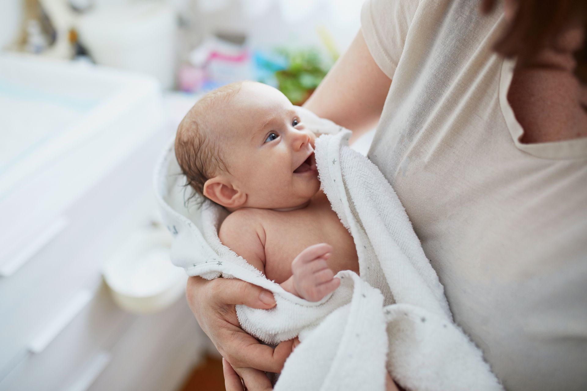 A mother drying her baby after a bath