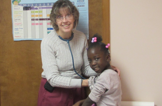 Pediatrician checking child's breathing